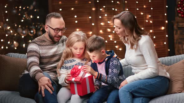 Happy Family Enjoying Christmas Eve Spirit with Presents Together