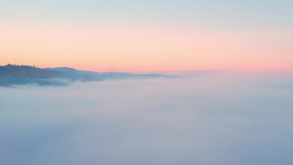 4K Drone Flying through the clouds at dusk or dawn. Aerial top cloudscape