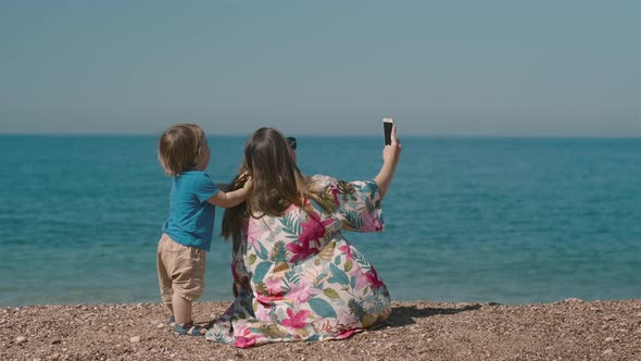 Happy millennial woman with a little boy making video call with parents