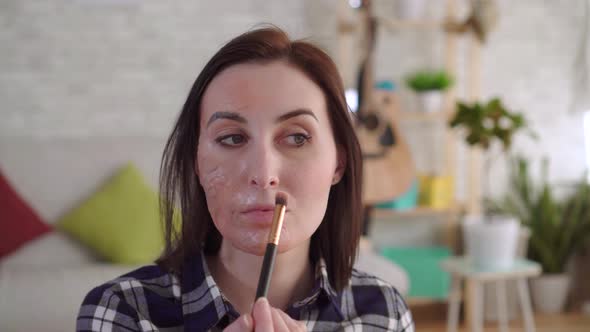 Young Woman Hides a Scar on Her Face with Makeup