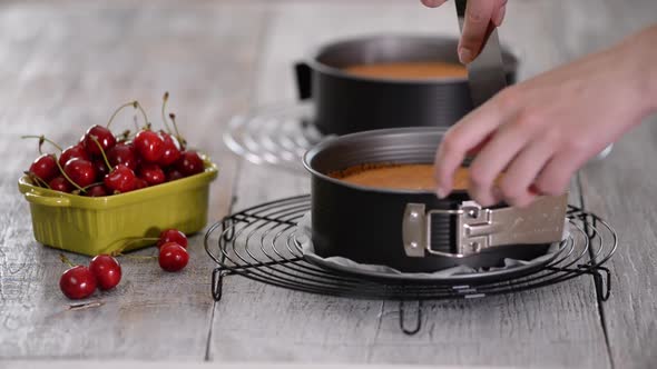 Cook Taking Out Layer Cake From Cake Form