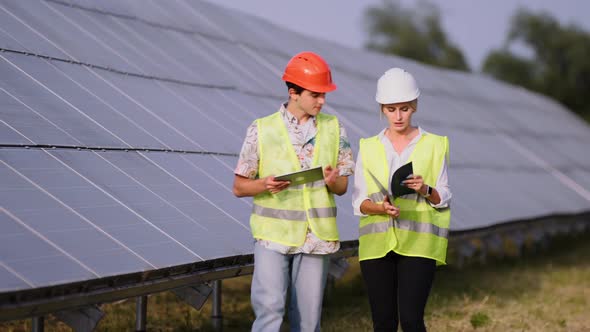 Two Engineers are Discussing Drawings for the Project