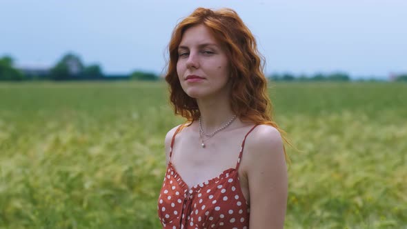 Portrait of Attractive Female on Grass at Sunset