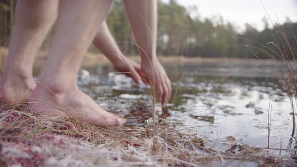 REVEAL An ice bather slips into the freezing water to start his cold water exposure