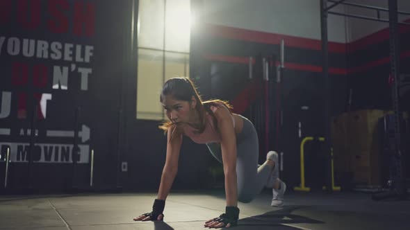 Athlete beautiful woman doing exercise by abdominal air bike pose or runing plank in fitness gym.