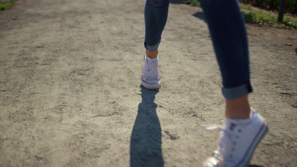 Closeup Woman Legs Walking in Sport Shoes