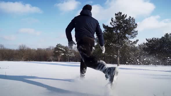 Happy Man Runs in Snow and Tumbles Funny