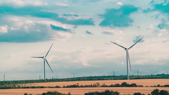 Time laps windmill is spinning against the backdrop of a beautiful cloudy sky