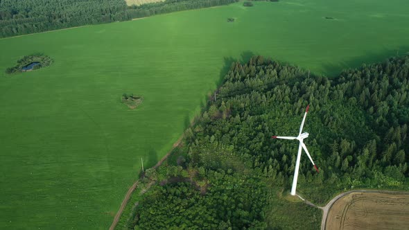 Windmills in Summer in a Green Field.large Windmills Standing in a Field Near the forest.Europe