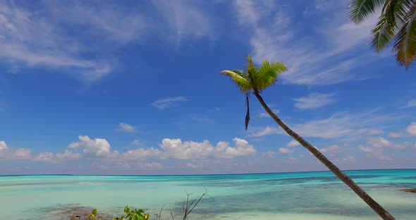 Natural aerial island view of a white sand paradise beach and blue water background in colourful 4K