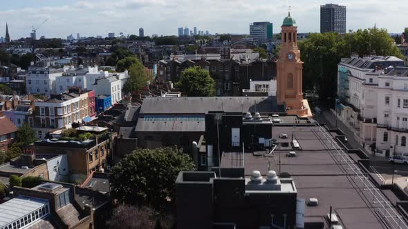 Forwards Fly Over Church with Clock Tower in Urban Neighbourhood