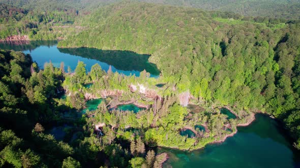 Aerial View Of Plitvice Lakes Surrounded By Lush Green Forests In Croatia. Dolly Drone shot