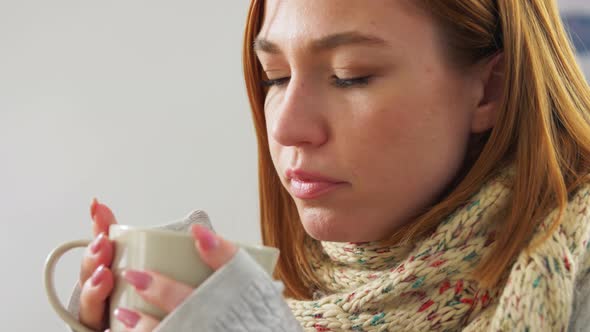 Sad Sick Young Woman Drinking Hot Tea at Home