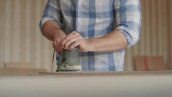 Carpenter Uses a Grinding Machine to Align