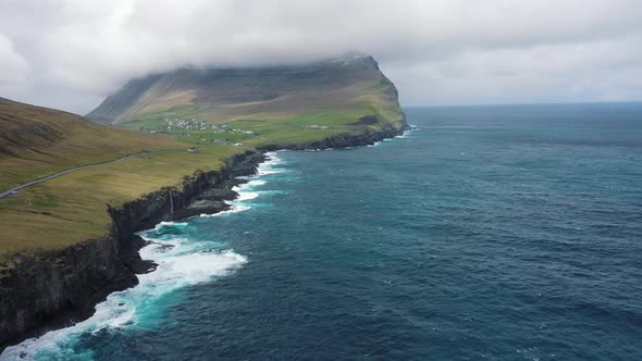 Flight Over a Coastline Towards the Village of Vidareidi on Faroe Islands