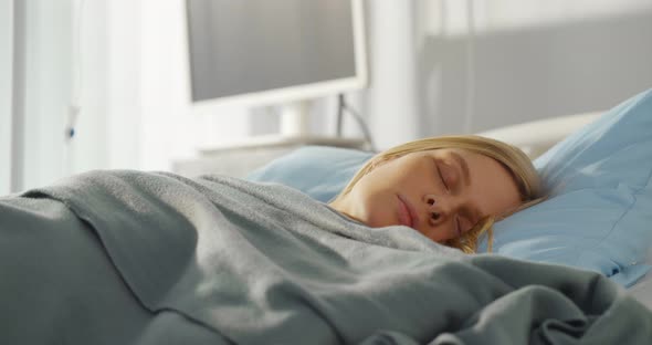 Close Up of Sick Young Woman Sleeping in Hospital Bed