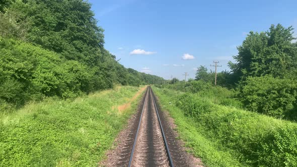 Blured Side View of Highspeed Turning End Back of Train on Landscape of Beautiful Nature Wild Field