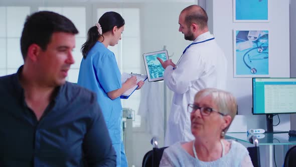 Doctor Checking Radiography on Nurse Digital Tablet