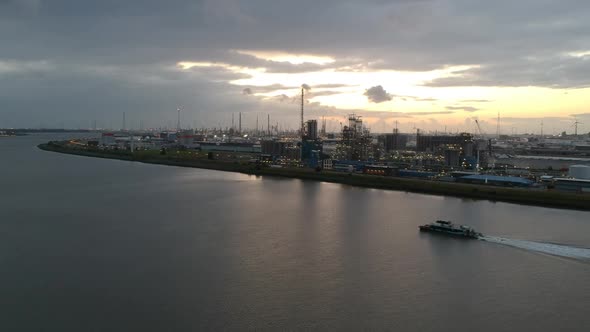 Industry buildings of Antwerp port while small boat sailing by, aerial view