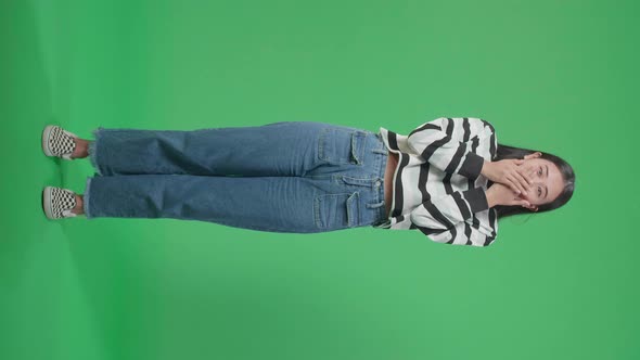 Full Body Of An Asian Woman Surprised  While Standing In Front Of Green Screen Background