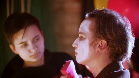 Make-up Artist Applying Paint on the Man Clown in the Dressing Room
