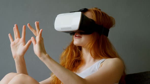 Woman using virtual reality headset in living room 4k