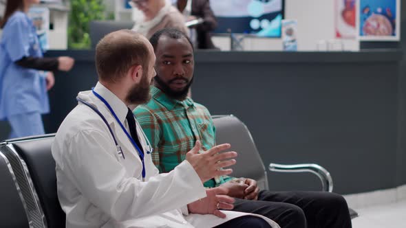 Diverse People Doing Consultation Exam in Hospital Reception Area