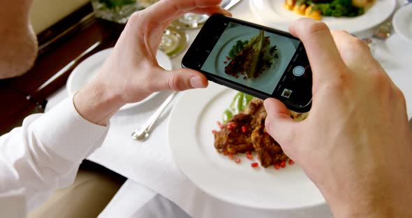 Businessman Taking Photo of Meal with Mobile Phone