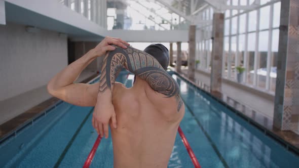 Man Stretching Before Swimming Practice