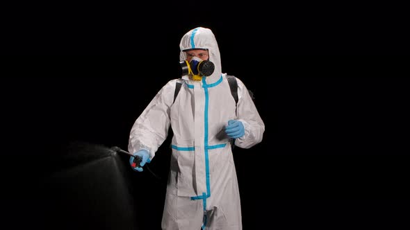 Medical Worker in a Protective Suit Against Bioviral Hazard Spray of Chemicals for Disinfection