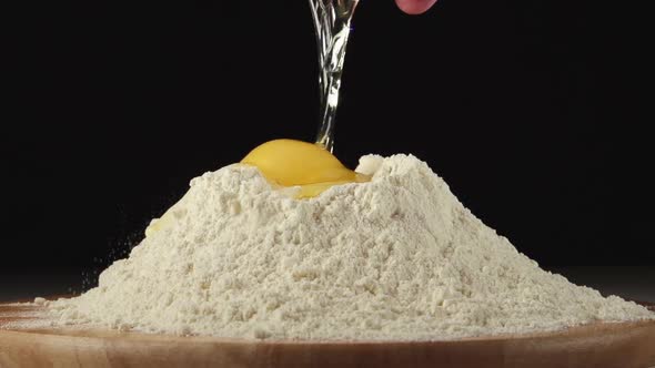 Human Hands Throw An Egg On A Pile Of Flour