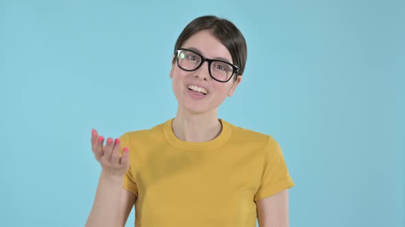 Young Woman Waving and Welcoming on Purple Background 