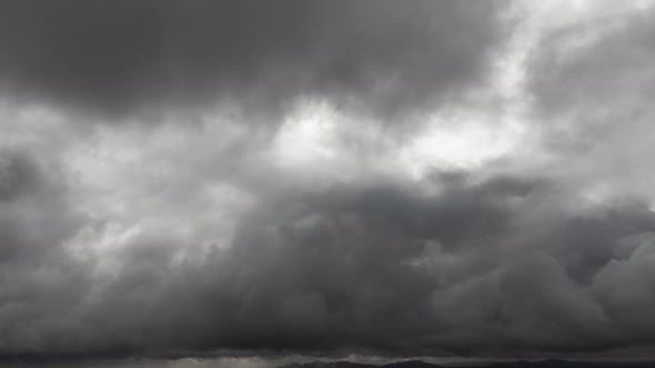 Time lapse of dark sky clouds background. The view from the drone traveling into the sky flying.