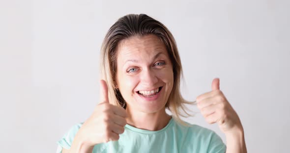 Cheerful Beautiful Woman Holding Thumbs Up and Dancing