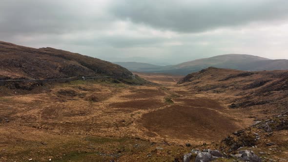 Molls Gap, Killarney, Kerry, Ireland, March 2022. Drone ascends and pushes south above Beaufort unde