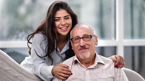 Cheerful Young Adult Daughter Granddaughter and Father Grandfather Posing