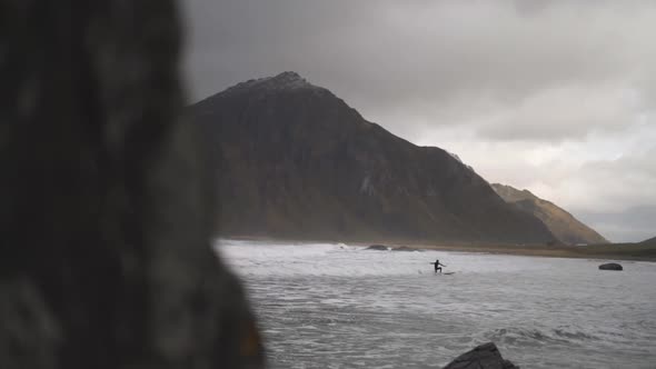 Surfer Surfing On Board In Rough Sea