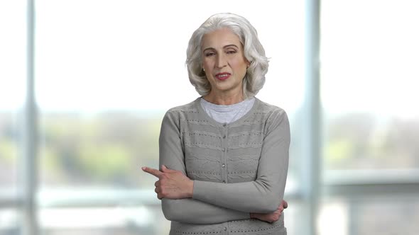 Portrait of an Old Woman with Folded Hands Pointing To the Left