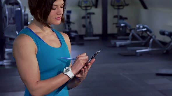 Fitness Woman Poses at the Gym