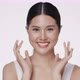 Close up portrait smiling young Asian girl massaging her beautiful face. - VideoHive Item for Sale