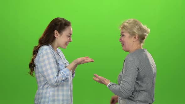 Woman Gives the Keys To Her Daughter . Green Screen. Side View. Slow Motion