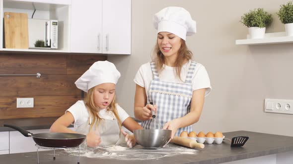 Happy Loving Caucasian Mom and Daughter Cooking Pizza and Having Fun in the Kitchen