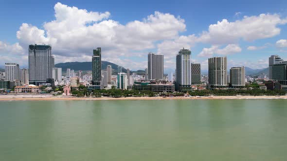 aerial drone view of the Nha Trang coastline at low altitude and transitioning to high altitude risi