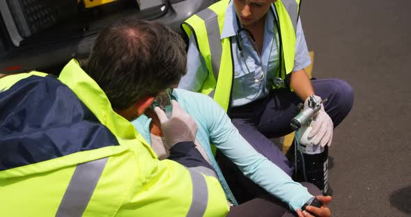 Patient receiving oxygen mask from ambulance team