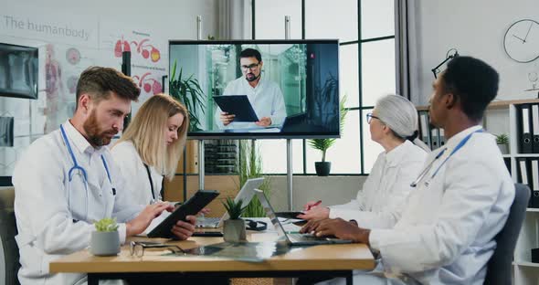 Team of Doctors Holding Online Meeting with Main Medical Manager on Digital Screen