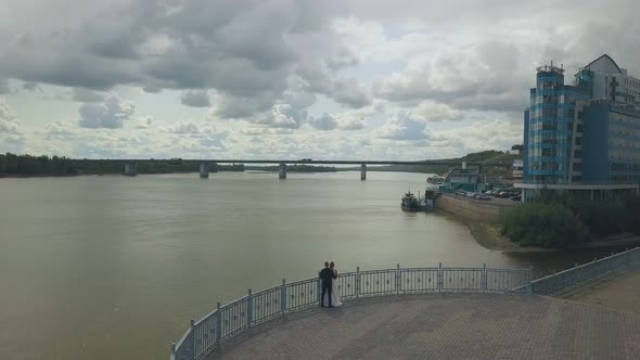 Newlywed Couple Enjoys Calm River From Viewpoint Aerial View