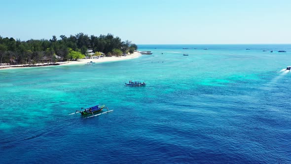 Beautiful flying tourism shot of a sunshine white sandy paradise beach and aqua blue water background