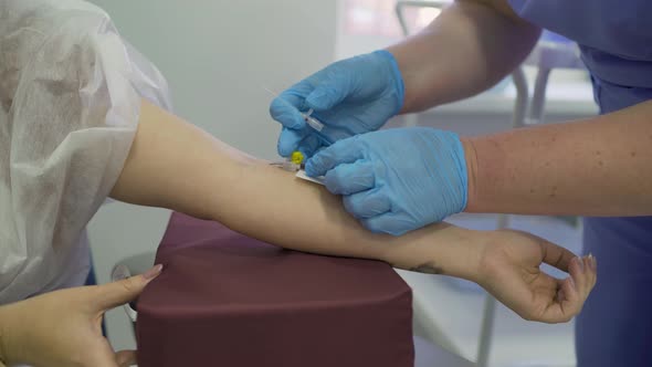 The doctor injects the patient into a vein