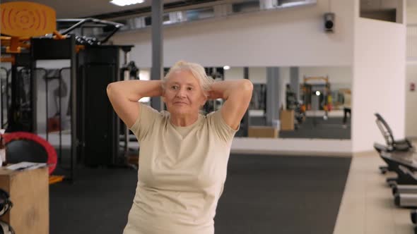 Elderly Woman Performs Exercises Physical Education