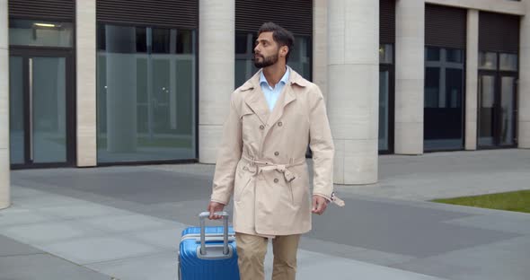 Slider Shot of Happy Businessman Going on Business Trip Walking Outside with Travel Suitcase